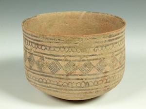 Wheel thrown terracotta bowl with red/brown paint applied to the surface - unglazed